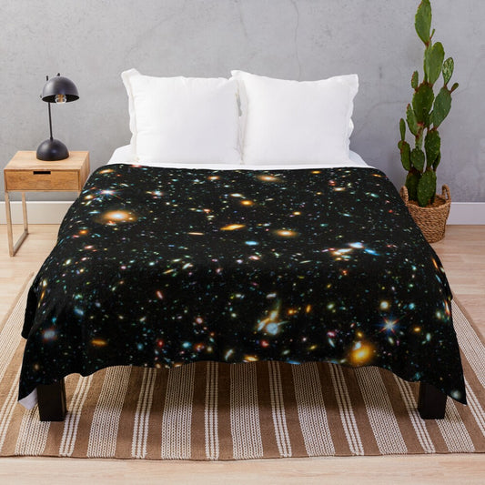 Hubble deep field inspired plush blanket with star field and galaxy design