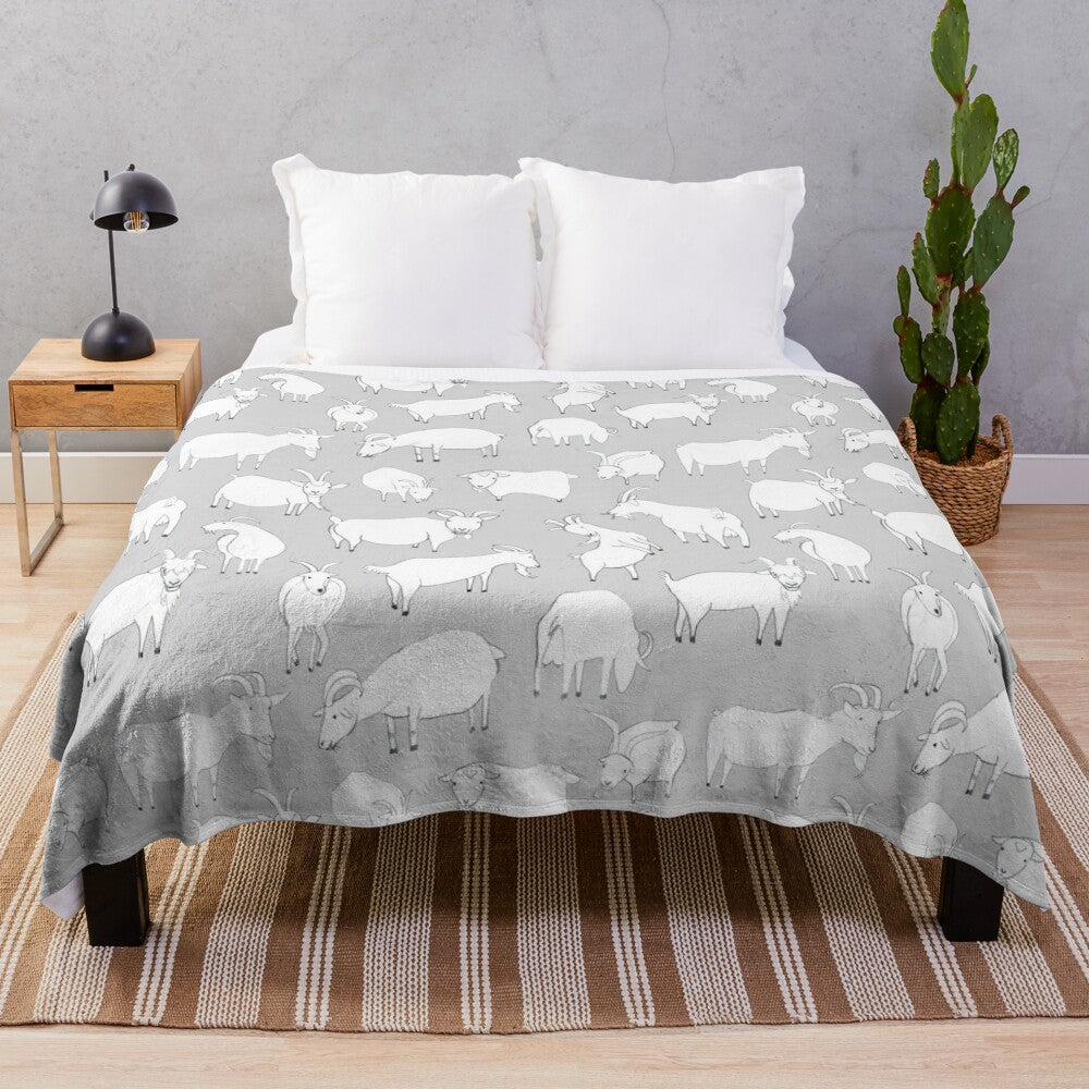 Grey plush blanket with a cute pattern of goats playing