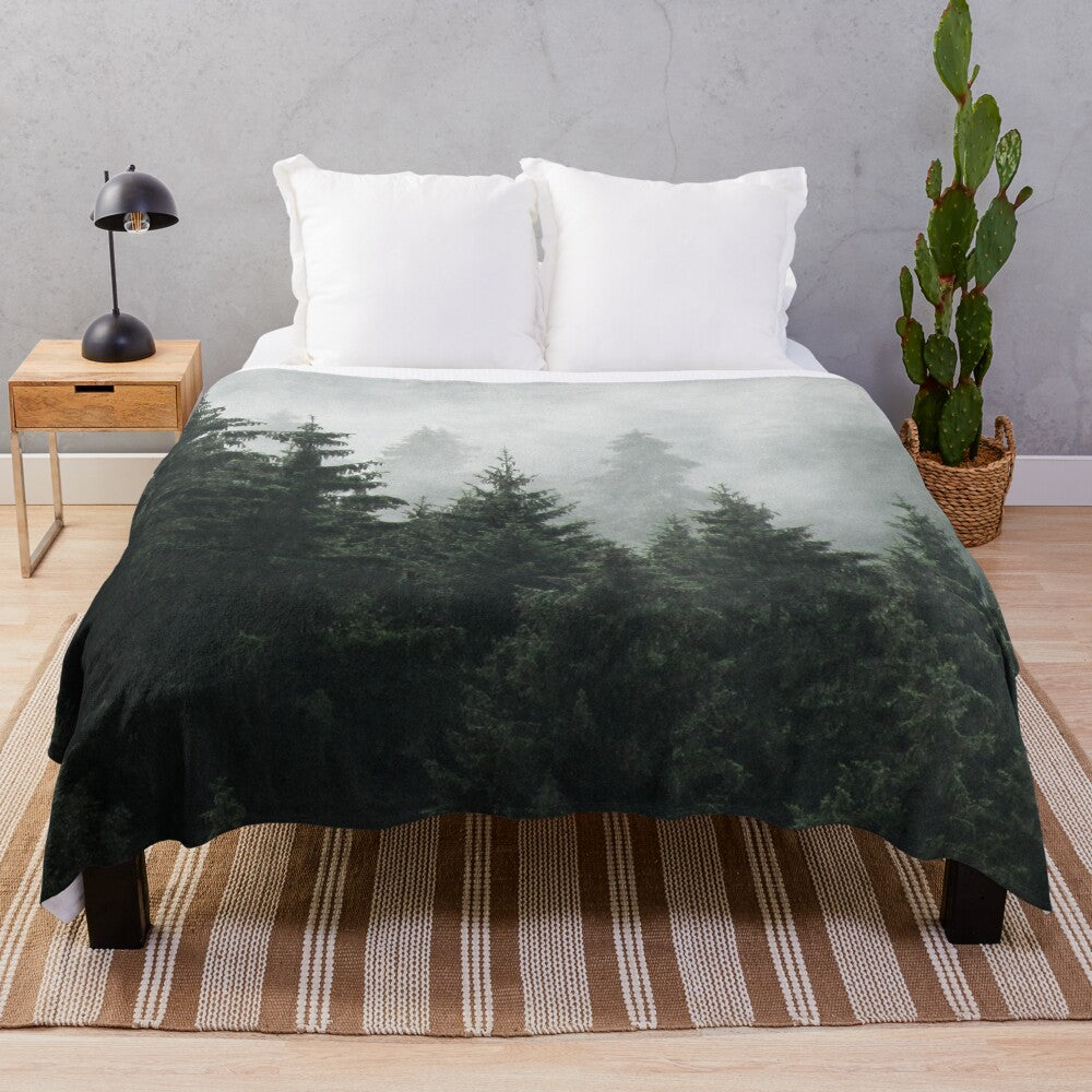 Plush blanket featuring a misty, foggy forest scene with Cascadia trees