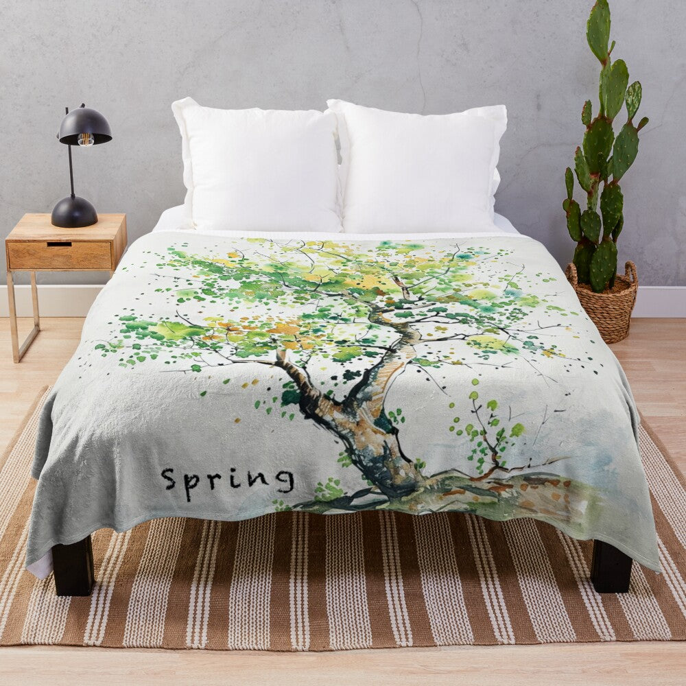 Vibrant plush blanket with a watercolor-style spring scene featuring a tree and leaves