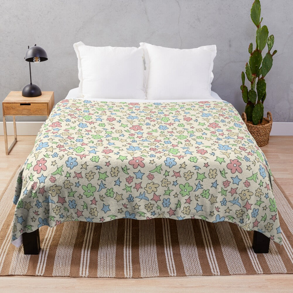 Soft and cozy plush blanket featuring a pattern of leaves, flowers, and stars