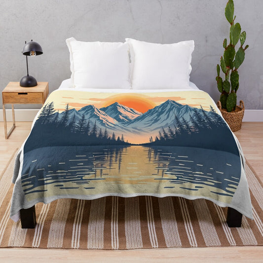 Mountains and lake sunset reflected in water with plush blanket