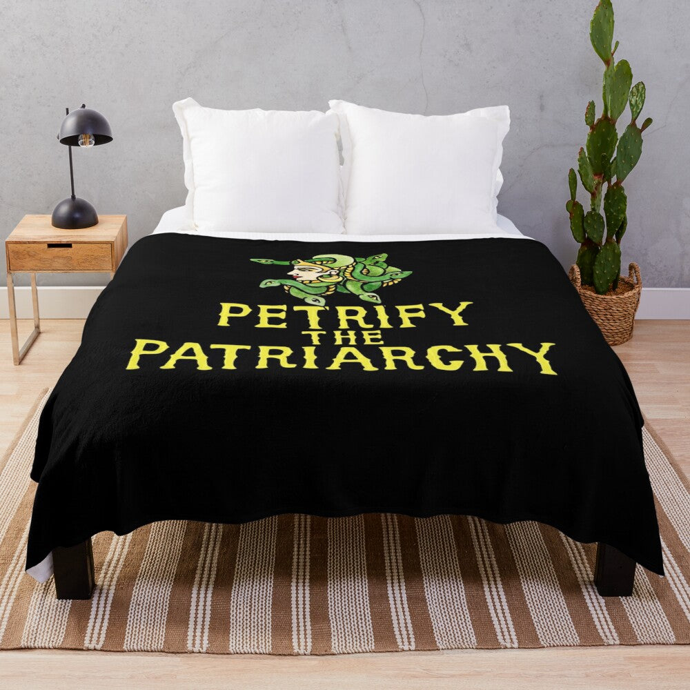 Plush blanket with a Medusa-inspired feminist design, encouraging people to "Petrify the Patriarchy"