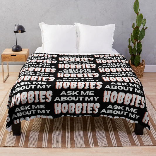 Plush blanket with "Ask me about my hobbies" design