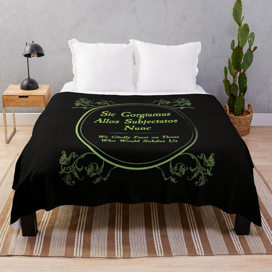 Addams Family inspired plush blanket featuring the iconic "Sic Gorgiamus Allos Subjectatos Nunc" quote