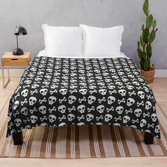 Spooky skulls and crossbones design on a black plush blanket