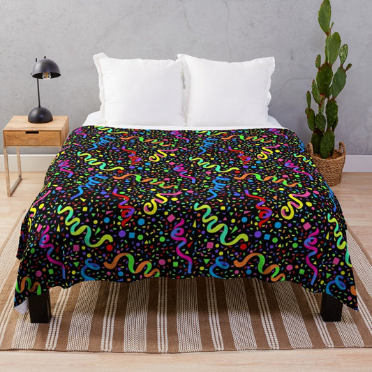 Colorful plush blanket with a retro arcade-inspired pattern of neon colors, confetti, and stars