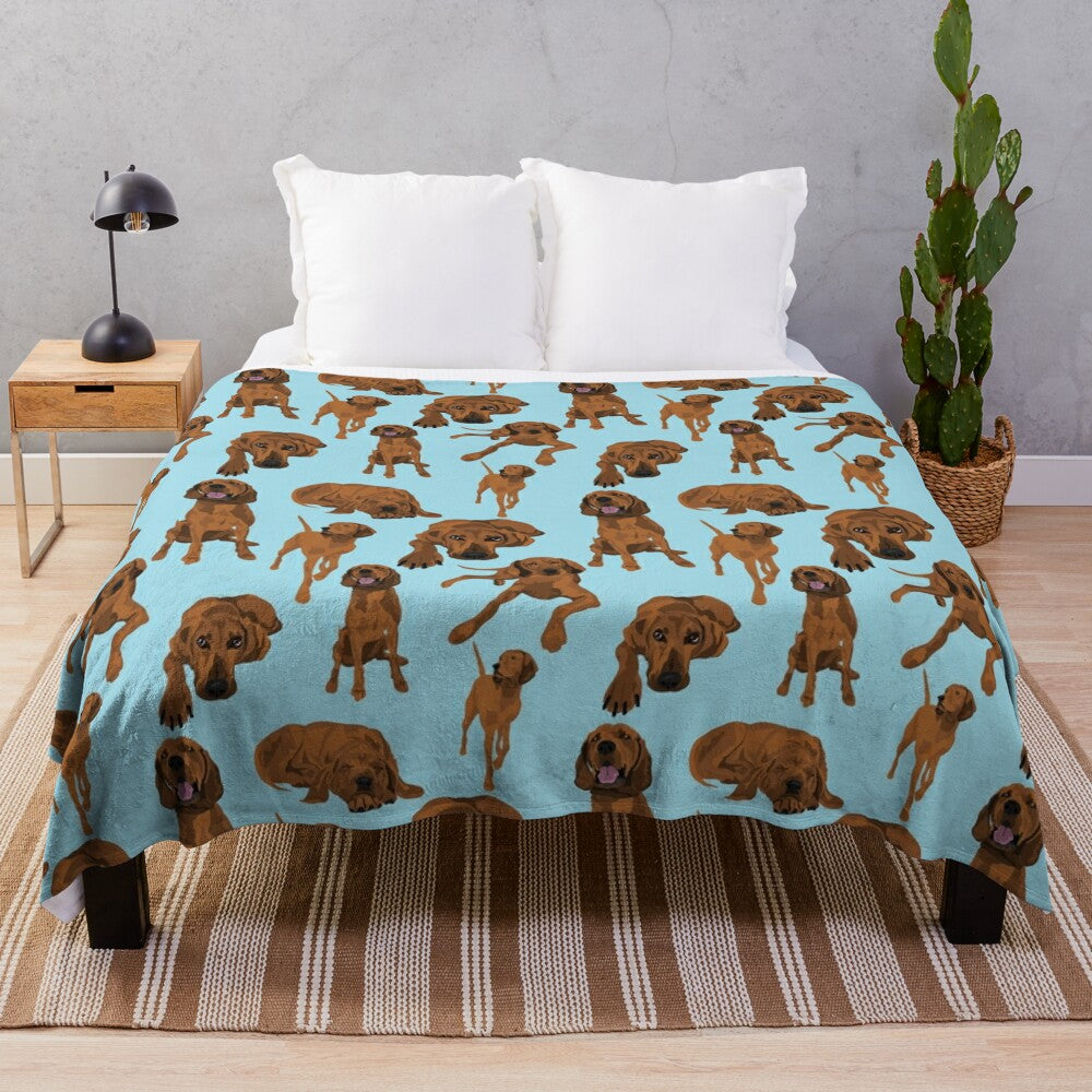 Redbone coonhound on a blue plush blanket with a vibrant dog pattern