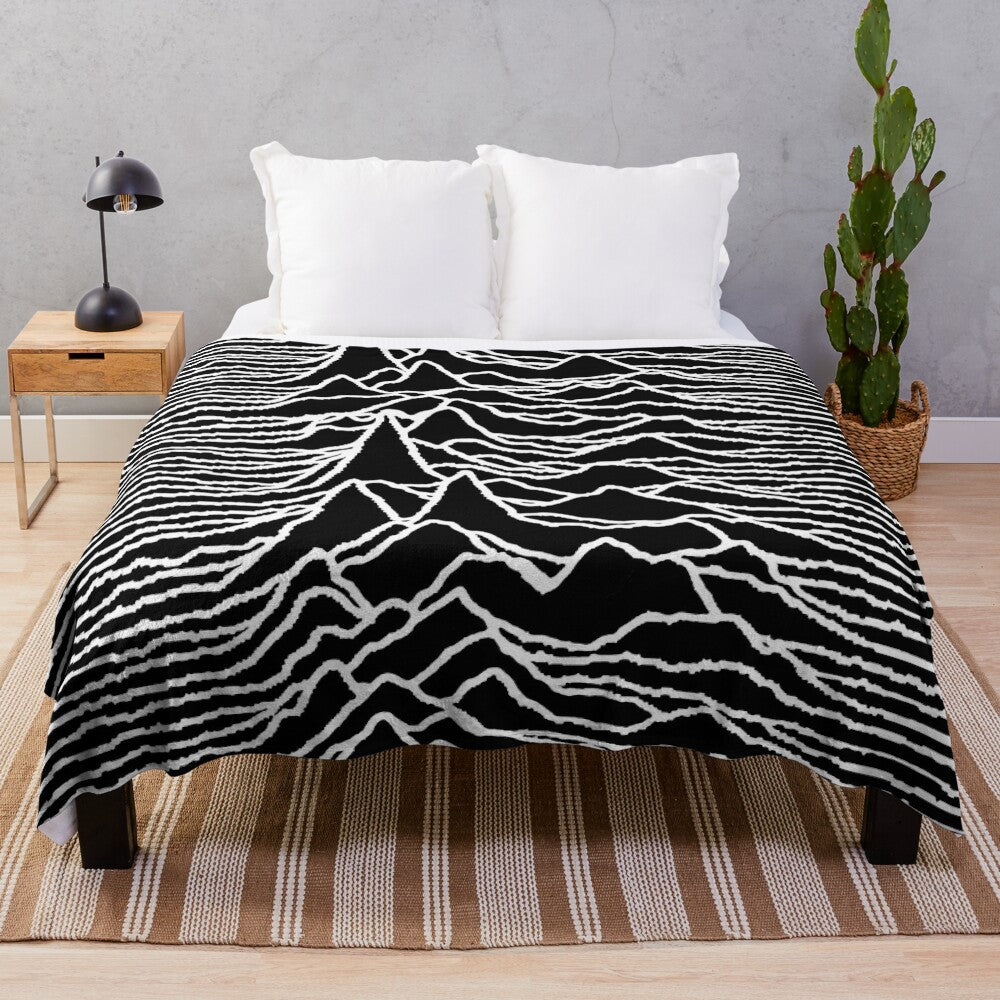 Plush blanket featuring the iconic "Unknown Pleasures" album cover design