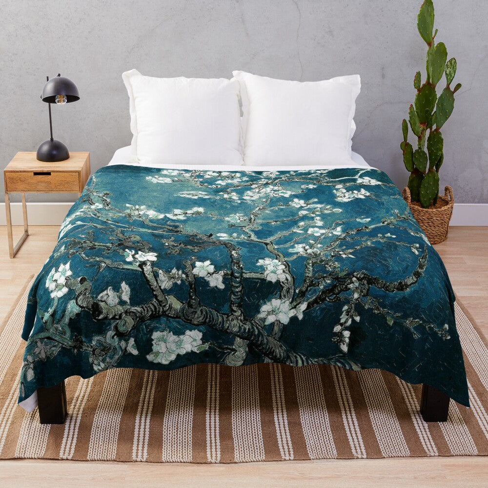 Teal plush blanket featuring an impressionist-style floral design inspired by Van Gogh's Almond Blossoms painting