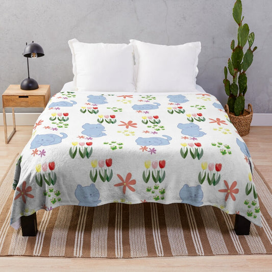 Plush blanket featuring a whimsical illustration of cats relaxing in a blooming flower garden