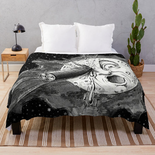 A cozy plush blanket featuring a space and cinema-themed design