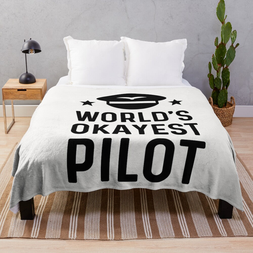 A cozy, soft plush blanket with the text "World's Okayest" printed on it, a humorous gift for engineers and other professionals.