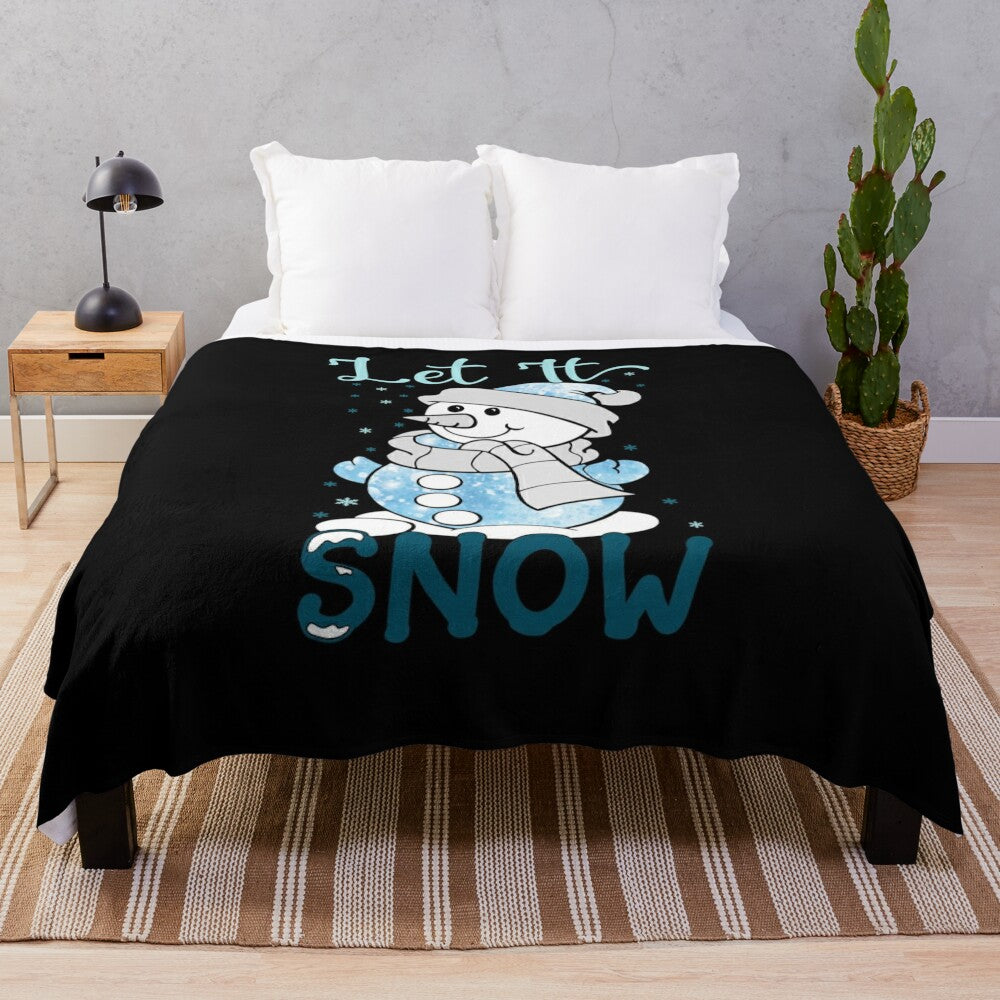 Plush white blanket with winter-inspired design featuring snowflakes and text "Let it Snow"