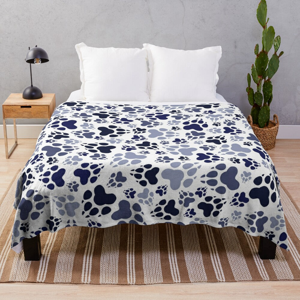 Blue plush dog blanket with paw print design