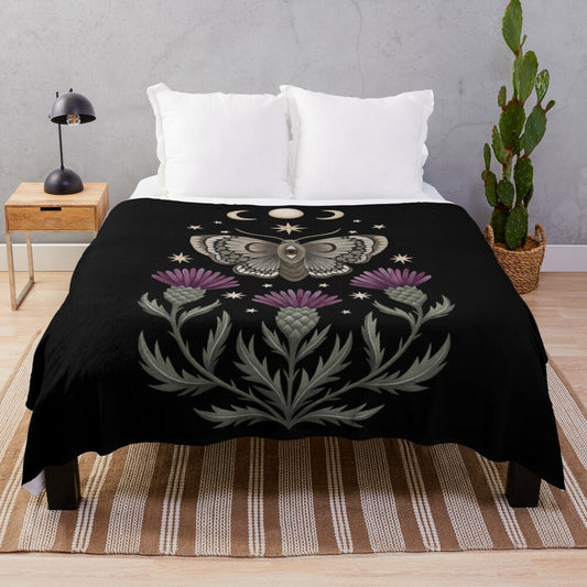 Enchanting plush blanket featuring a celestial moth design with flowers, thistles, and crescent moons