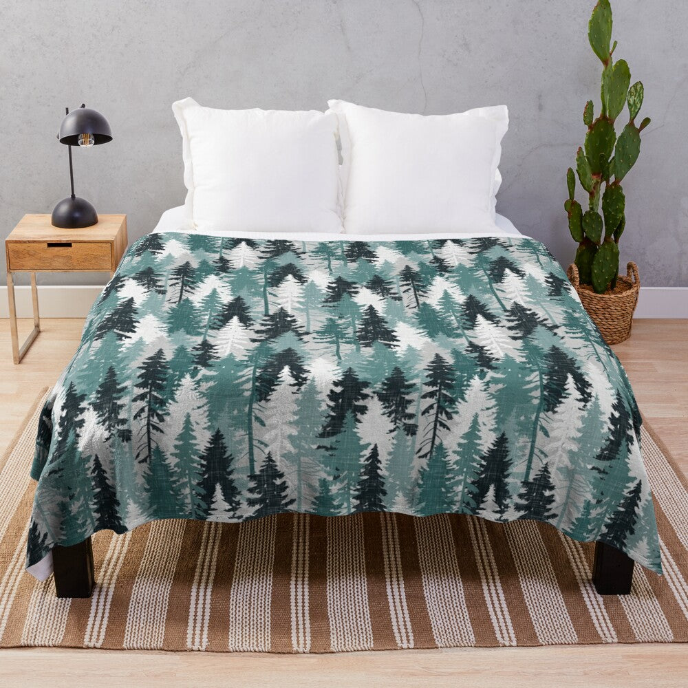 Teal plush blanket with cozy forest and tree pattern