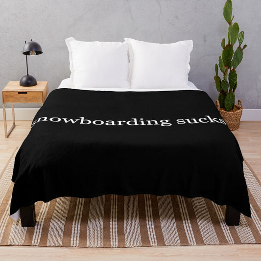 Plush black and white blanket with the text "snowboarding sucks" for winter sports enthusiasts