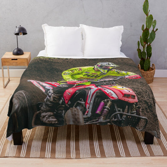 Plush blanket featuring an ATV quad racing through the mud