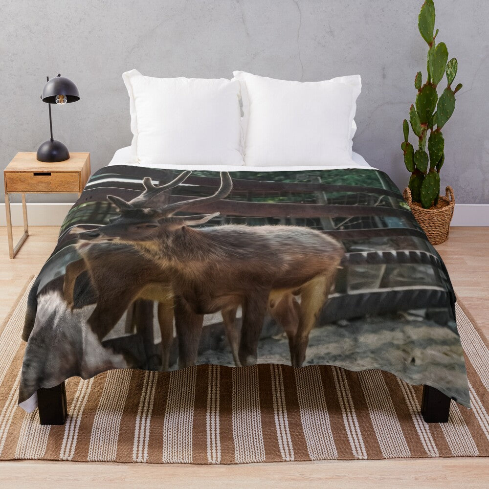 Plush blanket with illustrated reindeers and other animals