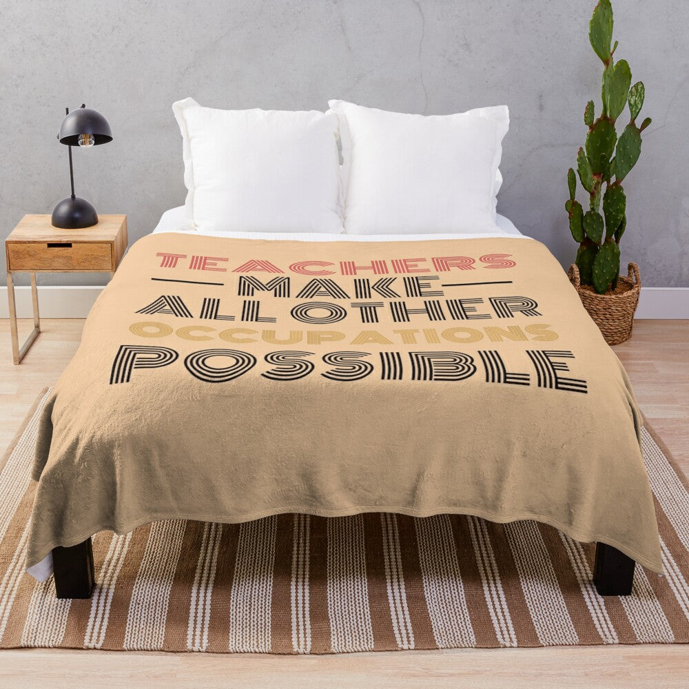 Black plush blanket with text "Teachers Make All Other Occupations Possible"