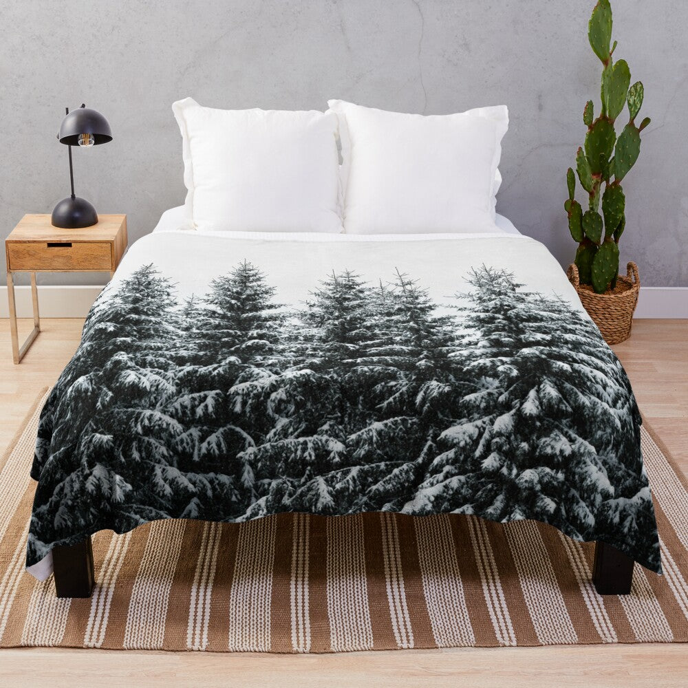 Plush blanket featuring a misty, foggy forest landscape with snow-covered trees