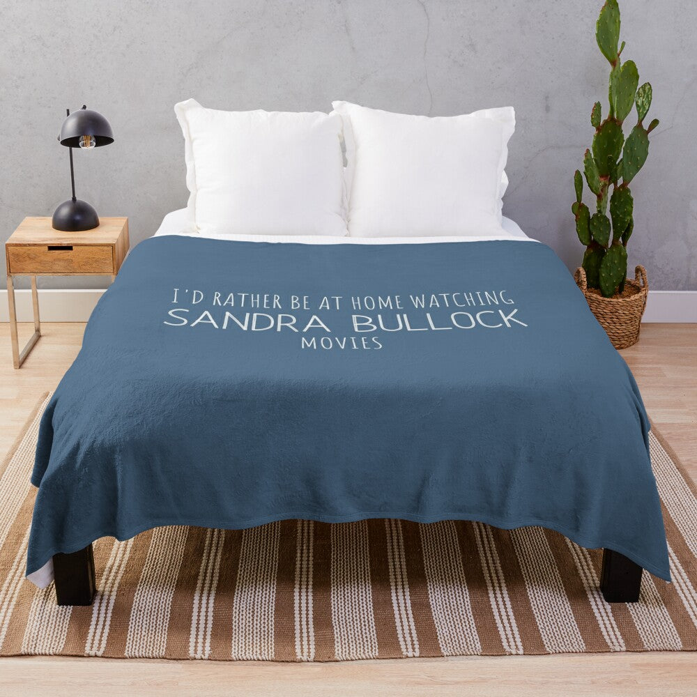 Cozy plush blanket with "I'd rather be at home watching Sandra Bullock movies" text