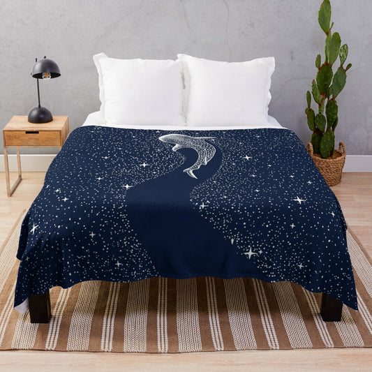 Plush blanket featuring a surreal artwork of a whale shark in a star-filled galaxy