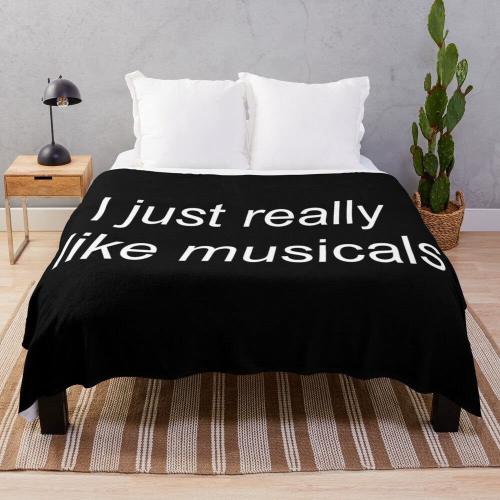 Musical theatre plush blanket with various musical logos and characters