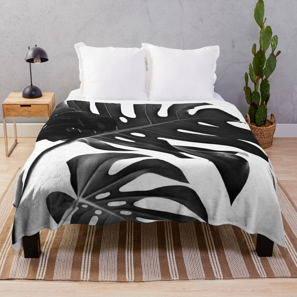 Black and white tropical monstera leaf plush blanket for modern botanical home decor