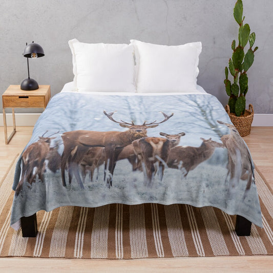 Red deer family in a snowy winter scene on a plush blanket