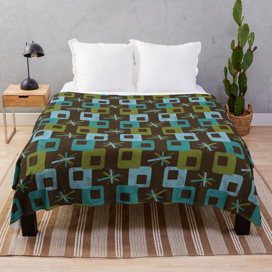 Teal geometric patterned plush blanket in a mid century modern style