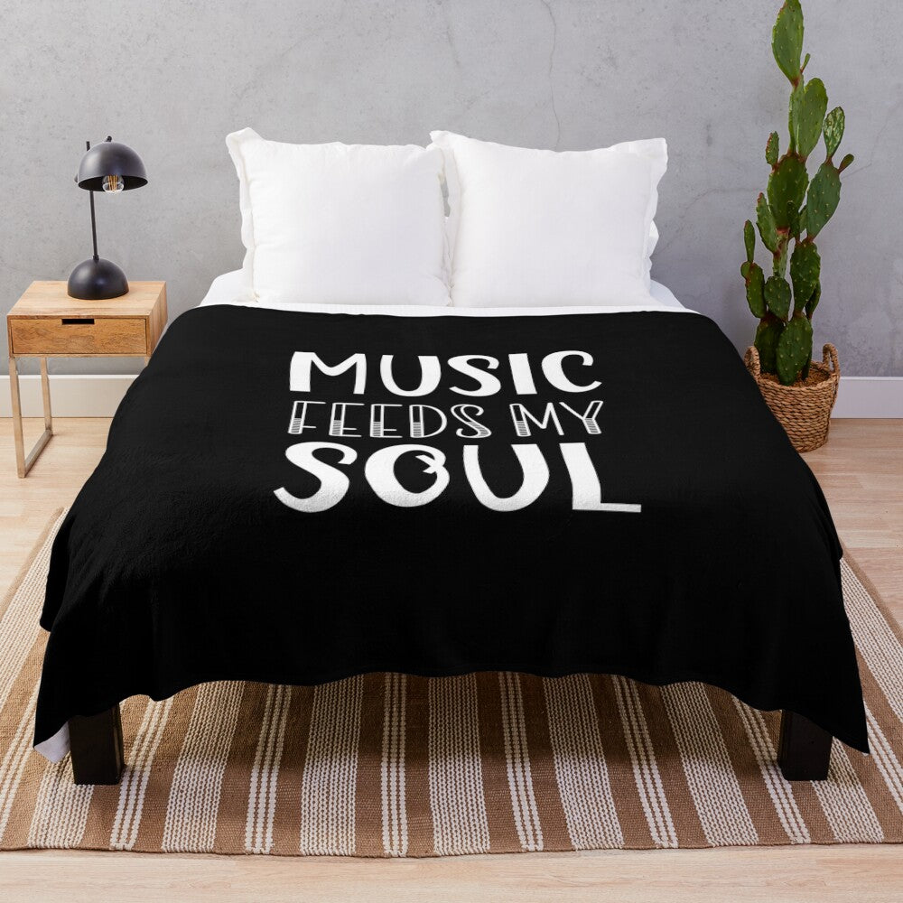 Plush blanket with music-inspired white and black text design