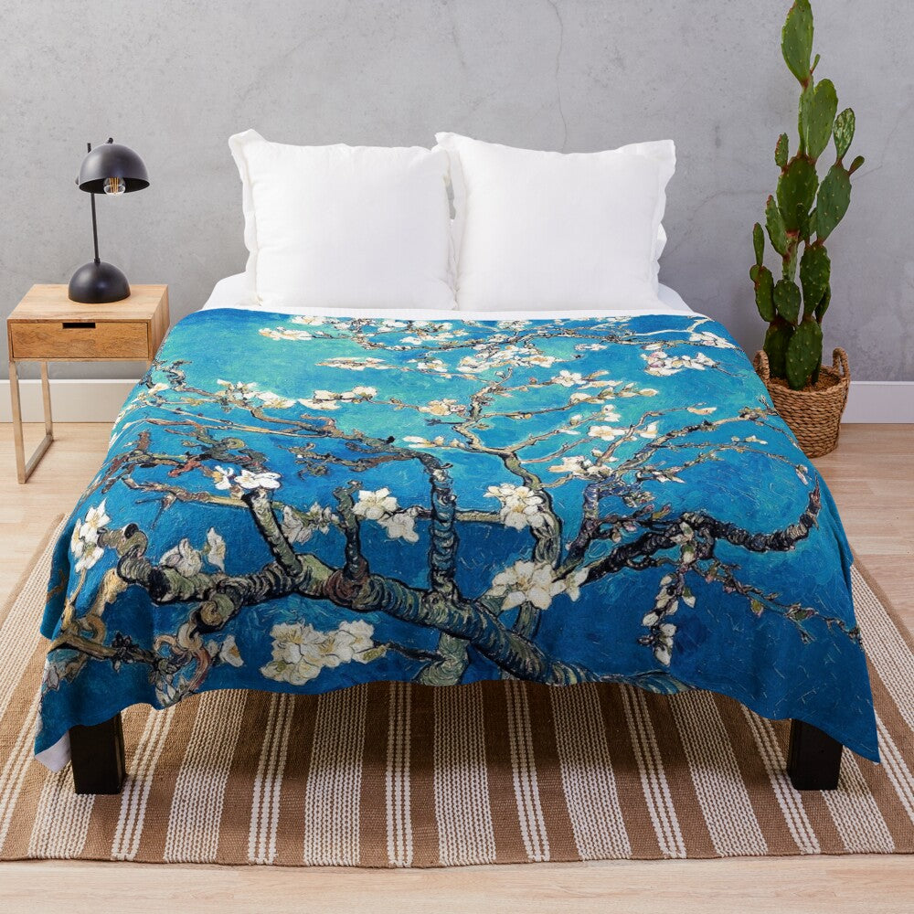 Turquoise plush blanket featuring a vincent van gogh inspired almond blossom floral design