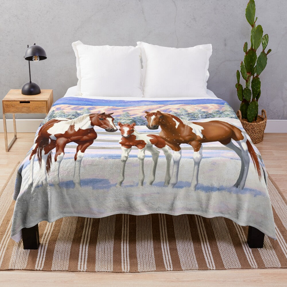 Chestnut pinto horses in snowy winter scene on a plush blanket