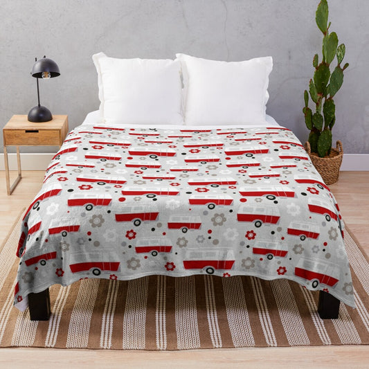 Vintage caravan-inspired plush blanket in red, white, and grey colors with a repeat pattern design