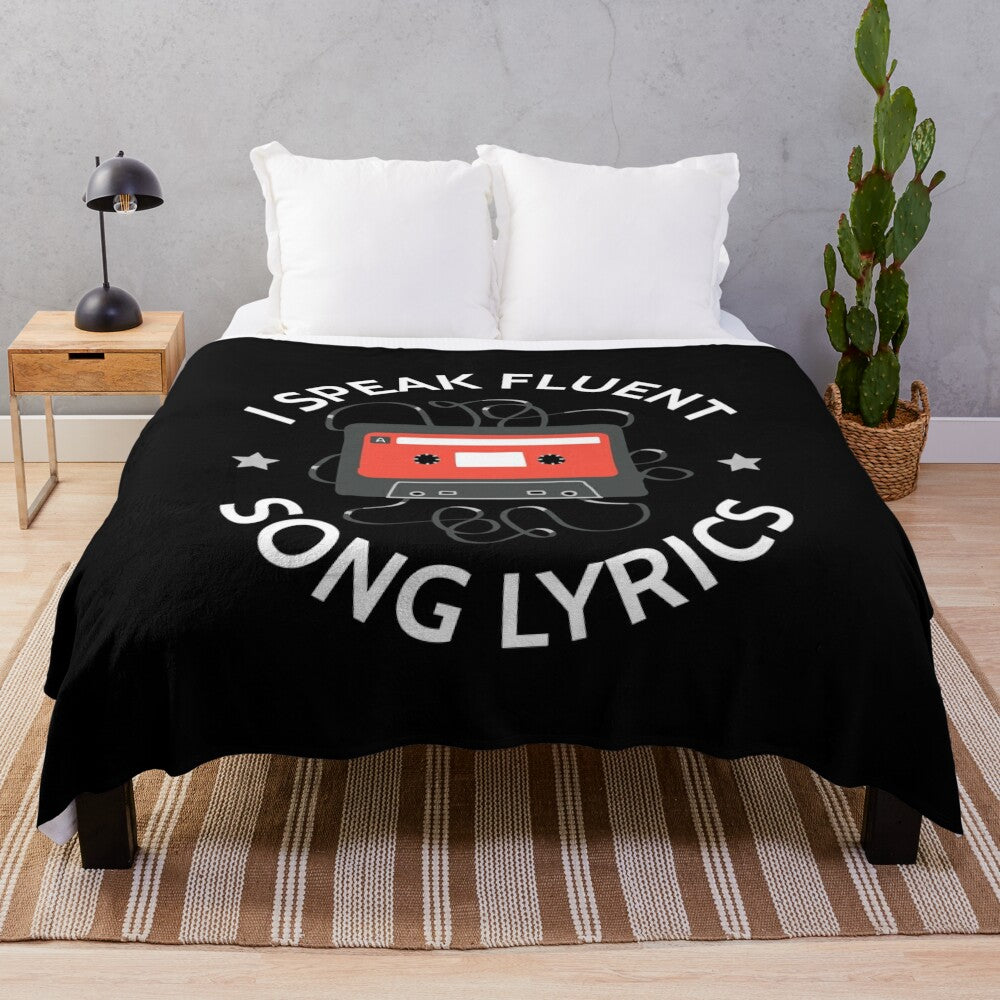 Plush blanket with "I Speak Fluent Song Lyrics" text and music-themed design