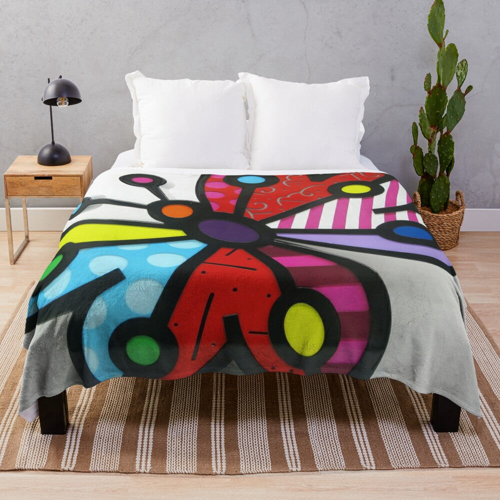 Colorful and playful plush blanket featuring the iconic pop art style of Brazilian artist Romero Britto