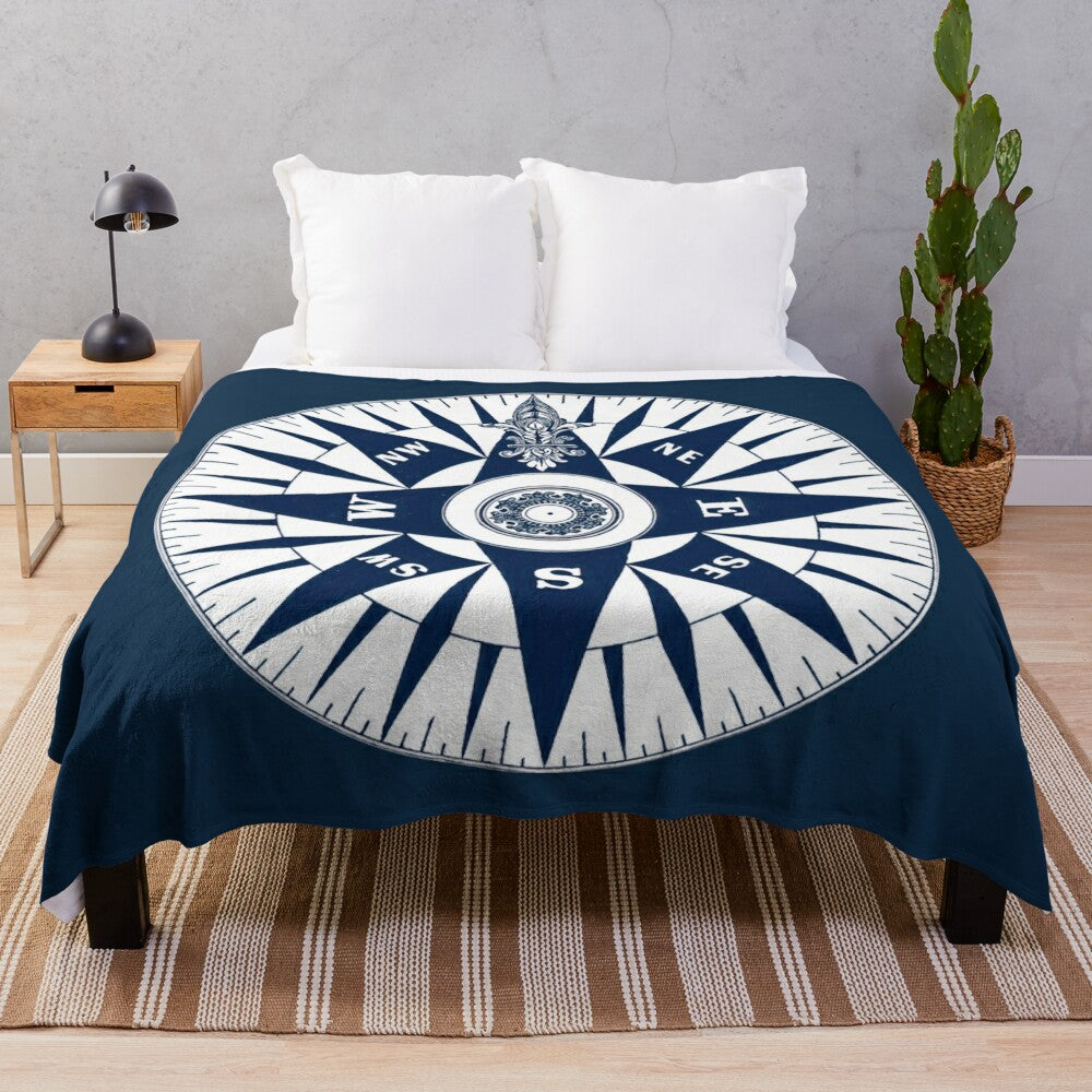 Ornate vintage nautical compass design on a navy blue plush blanket