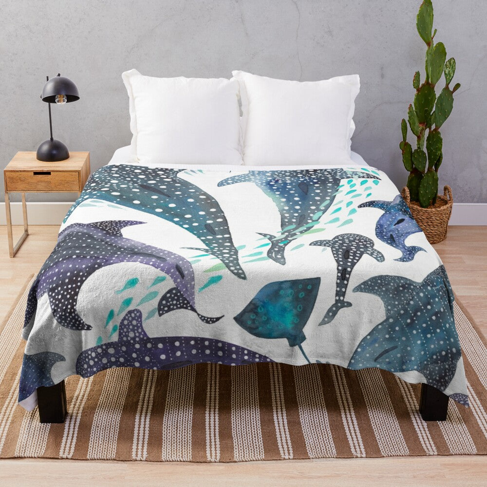 Watercolor print plush blanket featuring whale shark, ray, and other ocean creatures