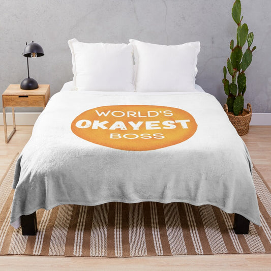 A plush blanket with the text "World's Okayest Boss" printed on it, a humorous and sarcastic gift for bosses.