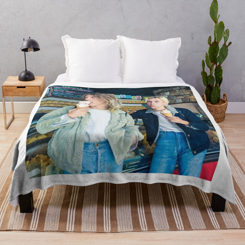 Cozy plush blanket featuring the artwork and branding of The Garden band