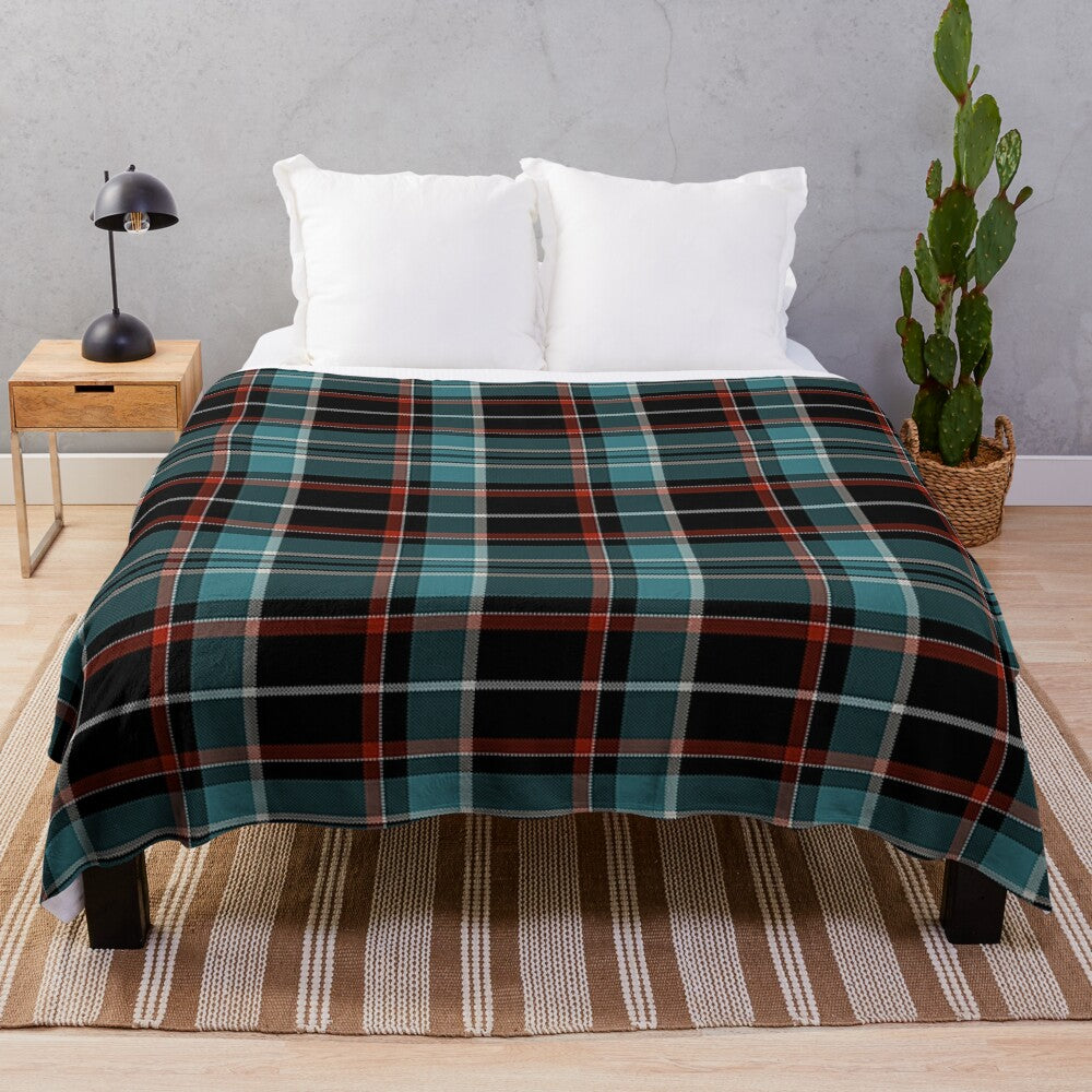 Plaid plush blanket in black, teal, and red colors