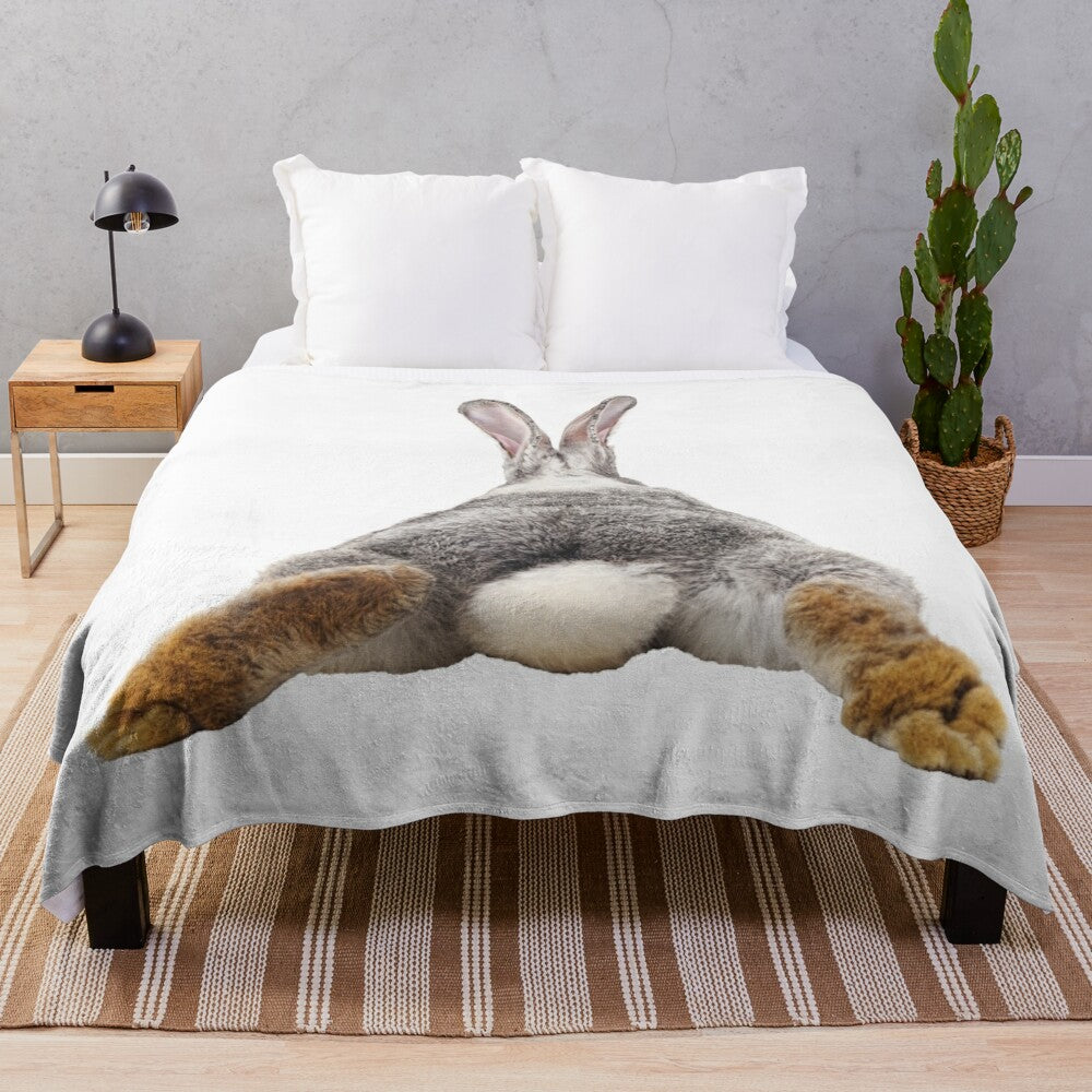 Cute bunny rabbit with tail and butt on plush blanket