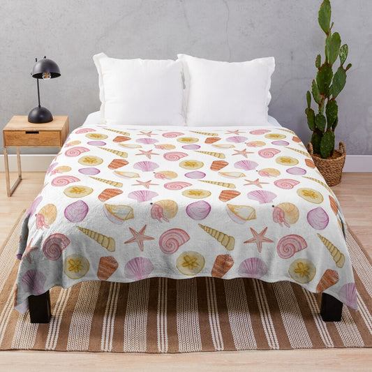 Plush blanket featuring a watercolor painting of seashells, crabs, and other ocean elements