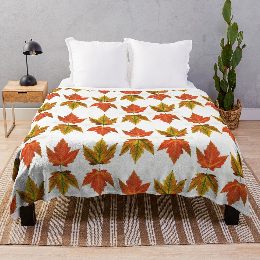 Autumn leaves plush blanket featuring a vibrant orange and red fall foliage design