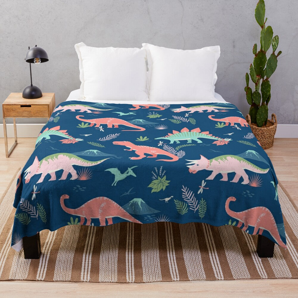 Jurassic dinosaur plush blanket in blue and coral colors