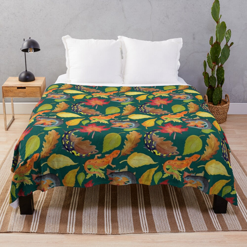 Dark green plush blanket with a watercolor pattern of salamanders and leaves