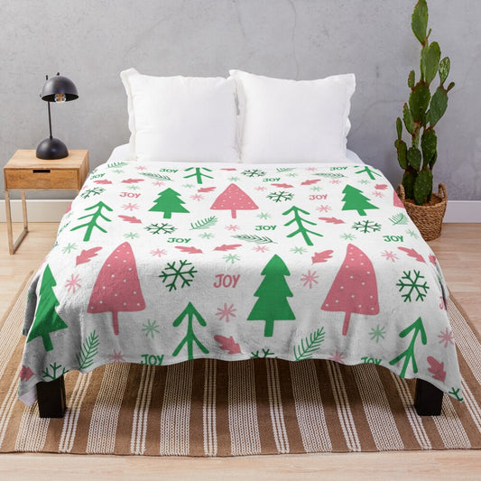 Soft plush blanket with festive winter holidays pattern in pink and green colors