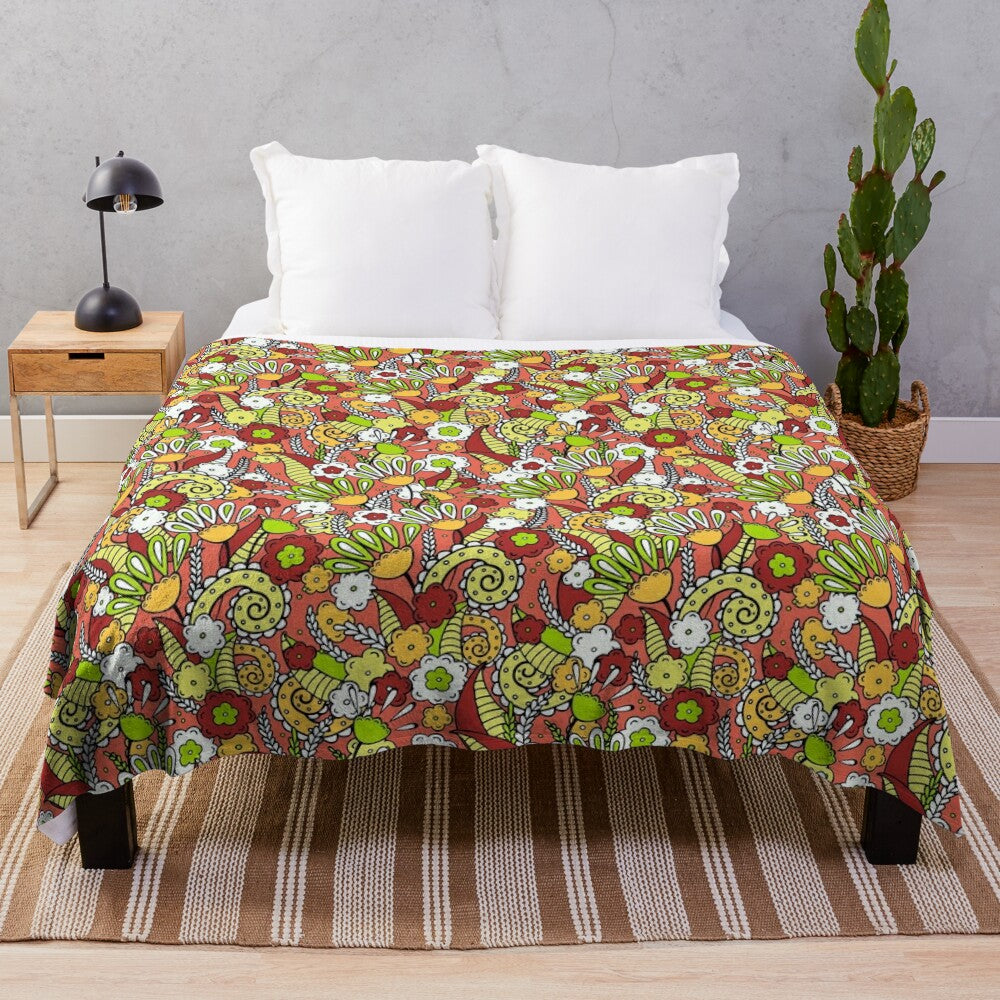 Plush blanket featuring a hand-drawn floral and doodle pattern on a terracotta background